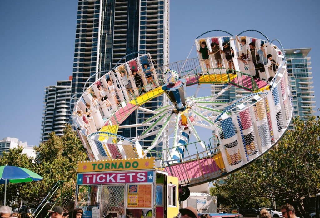 Exciting carnival ride set against city skyscrapers, capturing a lively urban atmosphere.